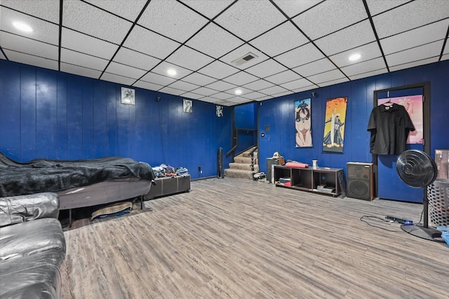 living room with hardwood / wood-style floors and a paneled ceiling