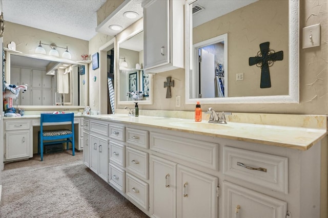 bathroom with vanity and a textured ceiling