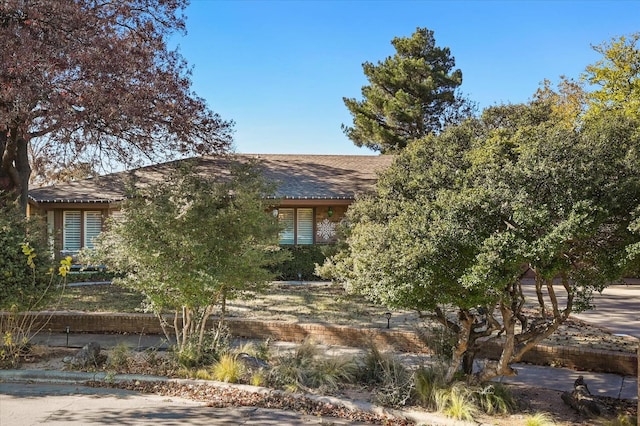 view of property hidden behind natural elements