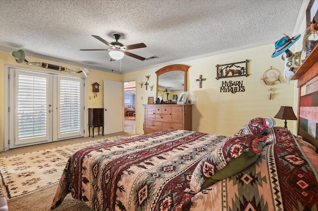 carpeted bedroom featuring ceiling fan, ornamental molding, access to exterior, and a textured ceiling