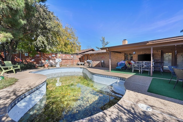 view of swimming pool with a patio