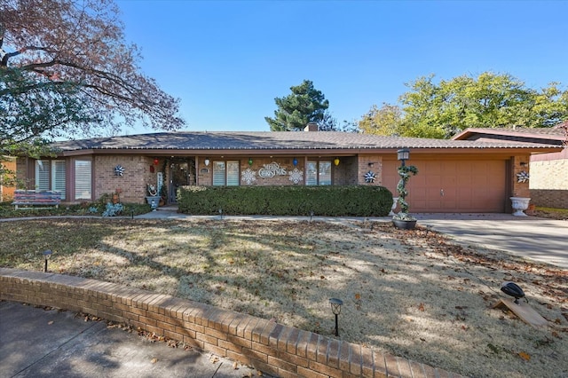 ranch-style home featuring a garage and a front lawn