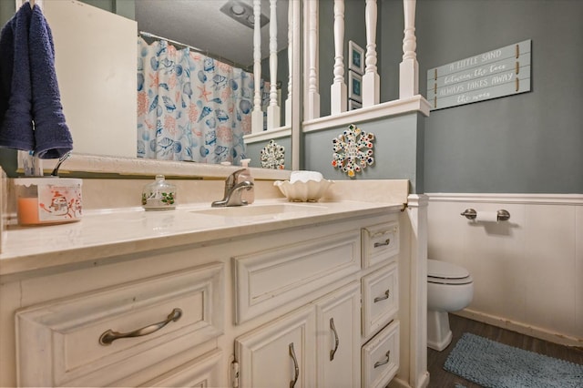 bathroom with vanity, hardwood / wood-style floors, and toilet