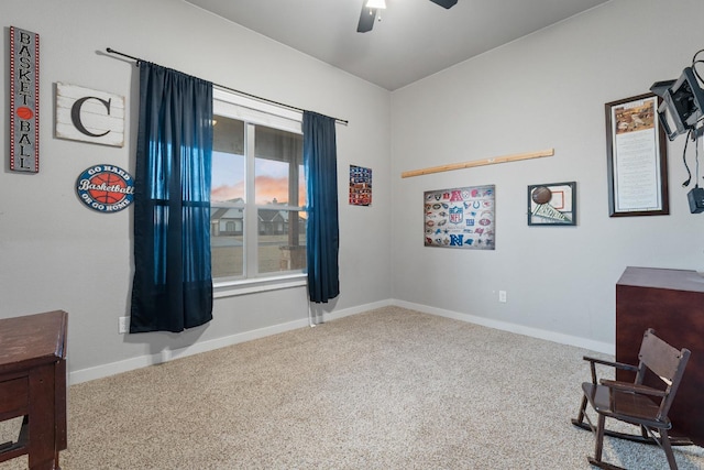 sitting room with ceiling fan and carpet