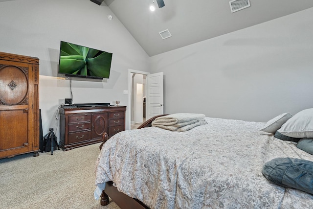 carpeted bedroom with ceiling fan and high vaulted ceiling