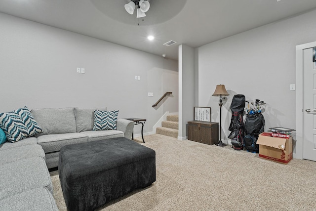 carpeted living room with ceiling fan