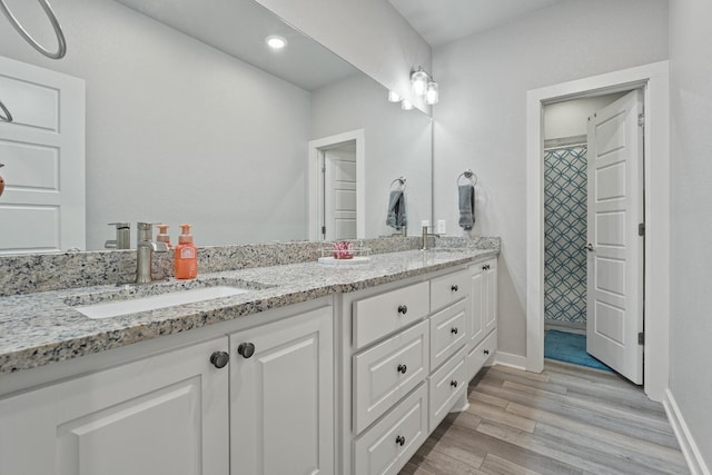 bathroom with vanity and hardwood / wood-style flooring