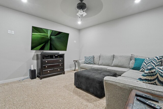 carpeted living room featuring ceiling fan