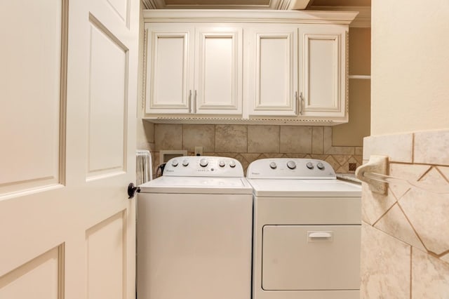 washroom with cabinets and washer and clothes dryer