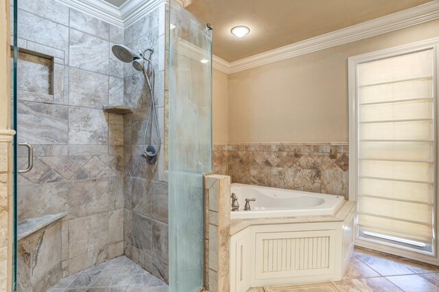 bathroom with ornamental molding and shower with separate bathtub