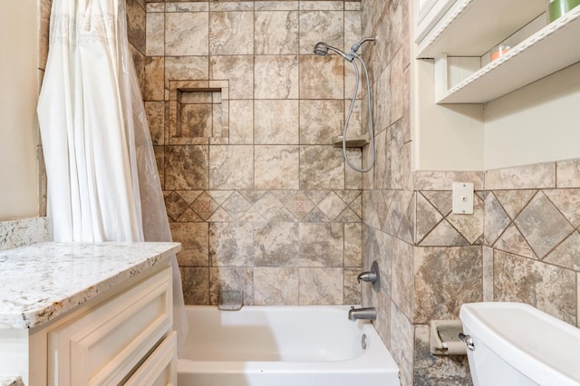 full bathroom with vanity, tile walls, toilet, and shower / bath combo with shower curtain