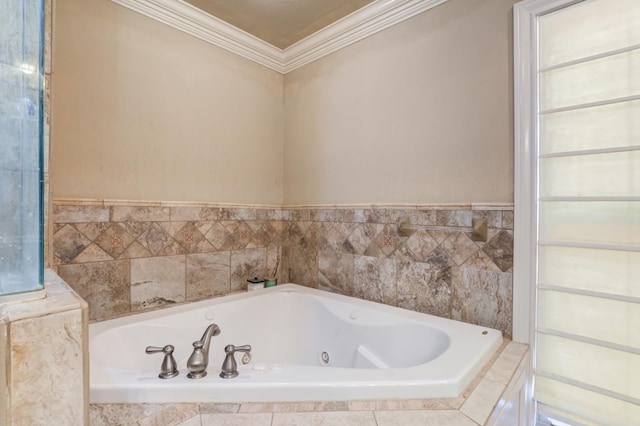 bathroom with ornamental molding and tiled bath