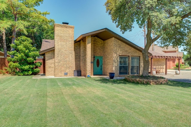 rear view of property featuring a yard and a pergola