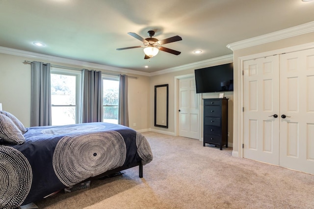 carpeted bedroom with crown molding and ceiling fan