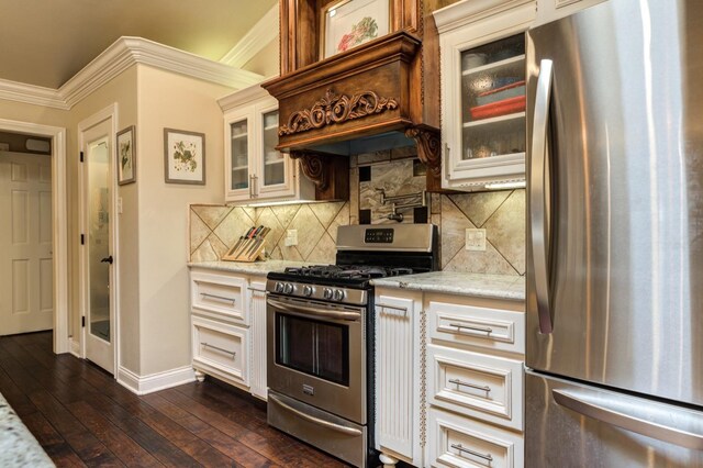 kitchen featuring ornamental molding, appliances with stainless steel finishes, dark hardwood / wood-style floors, and light stone countertops