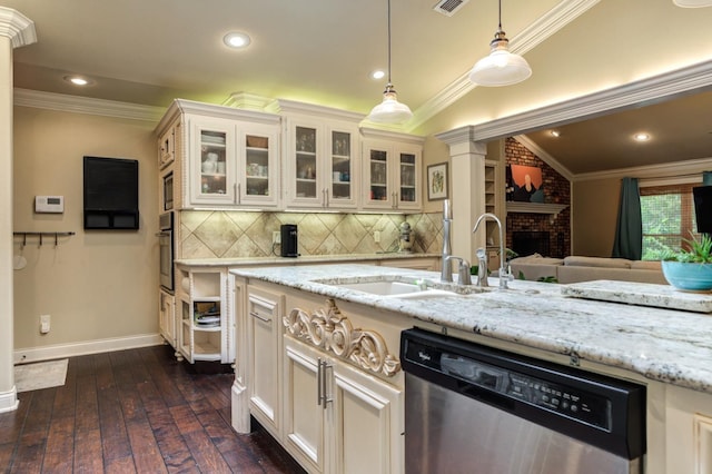 kitchen with stainless steel appliances, ornamental molding, white cabinets, and light stone counters