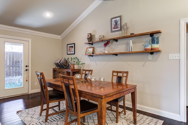 dining room with ornamental molding and dark hardwood / wood-style flooring