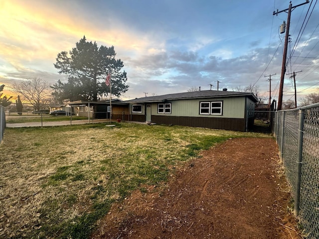 back house at dusk with a yard