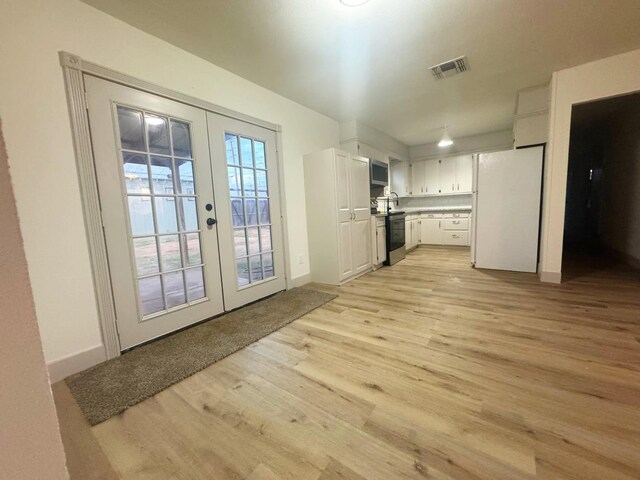 entryway featuring french doors and light hardwood / wood-style flooring