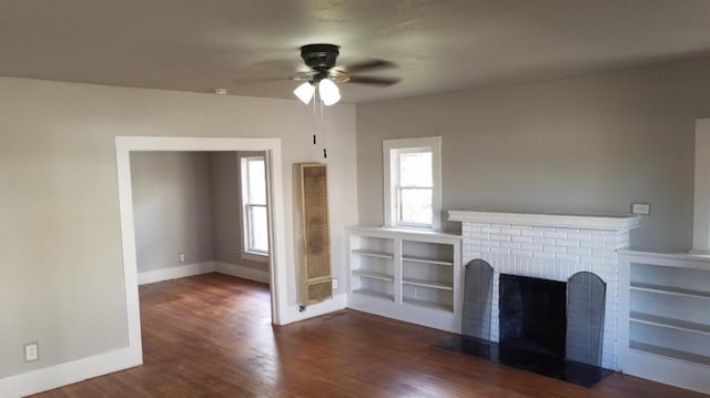 unfurnished living room featuring ceiling fan, dark wood-type flooring, and a fireplace