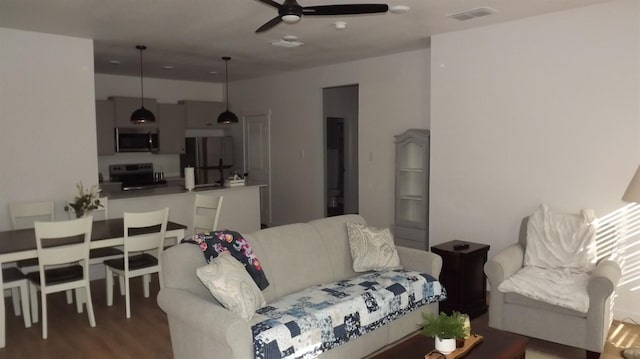 living room with hardwood / wood-style floors and ceiling fan