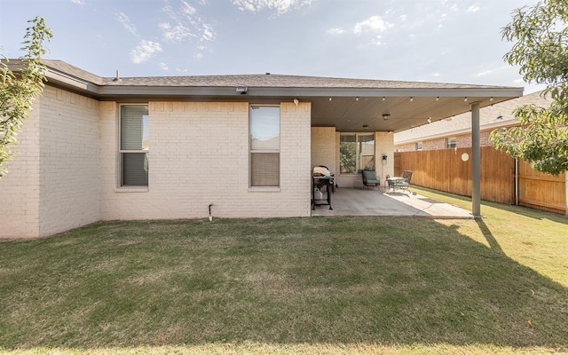 back of house with a yard and a patio area