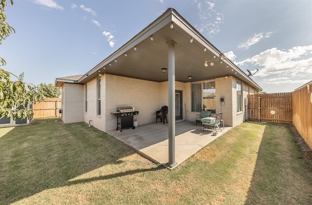 back of house featuring a yard and a patio