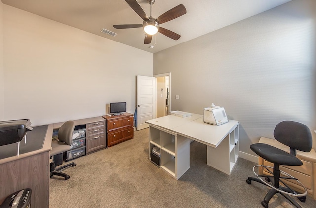 carpeted home office featuring ceiling fan