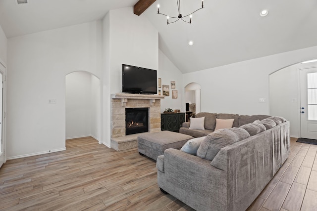 3615 121st St, Lubbock, TX 79423 - living area with arched walkways, beamed ceiling, high vaulted ceiling, light wood-style floors, and a chandelier