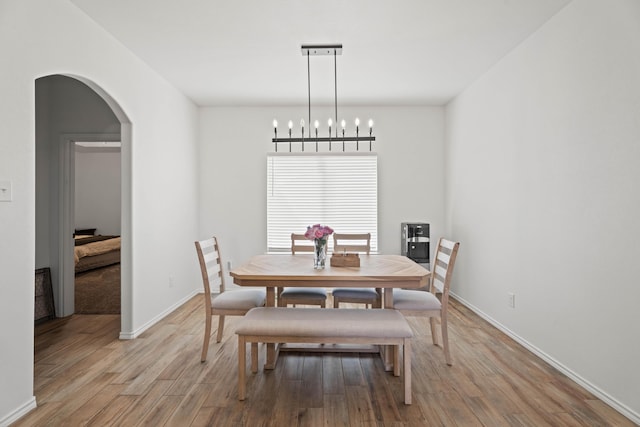 3615 121st St, Lubbock, TX 79423 - dining area featuring arched walkways and light wood finished floors