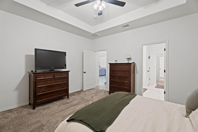 3615 121st St, Lubbock, TX 79423 - bedroom with light colored carpet, a raised ceiling, and a ceiling fan
