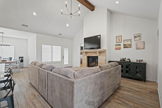 3615 121st St, Lubbock, TX 79423 - living room featuring a chandelier, beamed ceiling, high vaulted ceiling, light wood-type flooring, and a fireplace