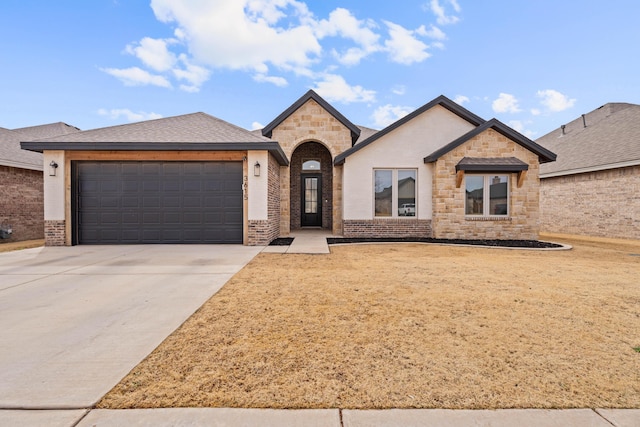 3615 121st St, Lubbock, TX 79423 - french country home with an attached garage, concrete driveway, brick siding, and stone siding