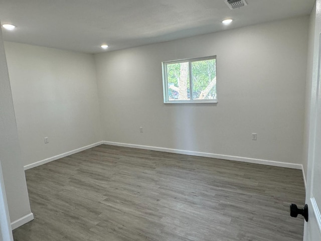 spare room with dark hardwood / wood-style flooring