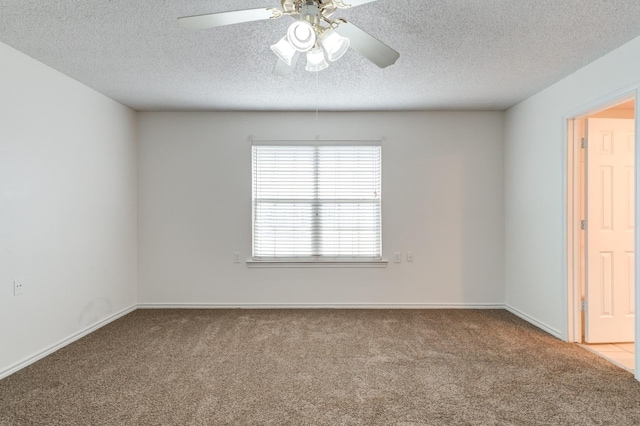 carpeted empty room featuring a textured ceiling and ceiling fan