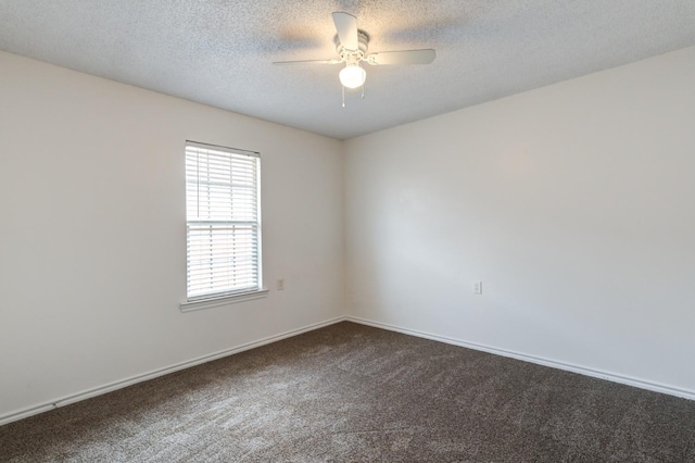 carpeted spare room featuring a textured ceiling and ceiling fan