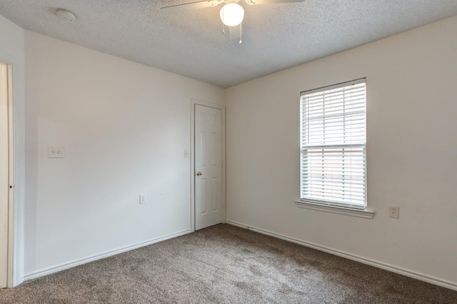 spare room with ceiling fan, carpet floors, and a textured ceiling