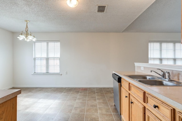 kitchen featuring sink, decorative light fixtures, light tile patterned floors, stainless steel dishwasher, and a notable chandelier