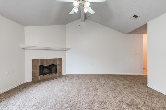 unfurnished living room with lofted ceiling, a fireplace, carpet floors, and ceiling fan