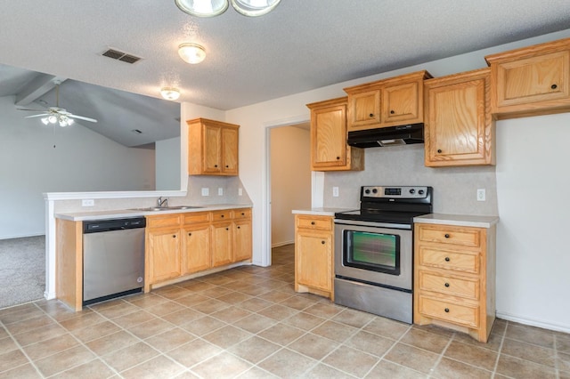 kitchen with sink, ceiling fan, appliances with stainless steel finishes, vaulted ceiling with beams, and a textured ceiling