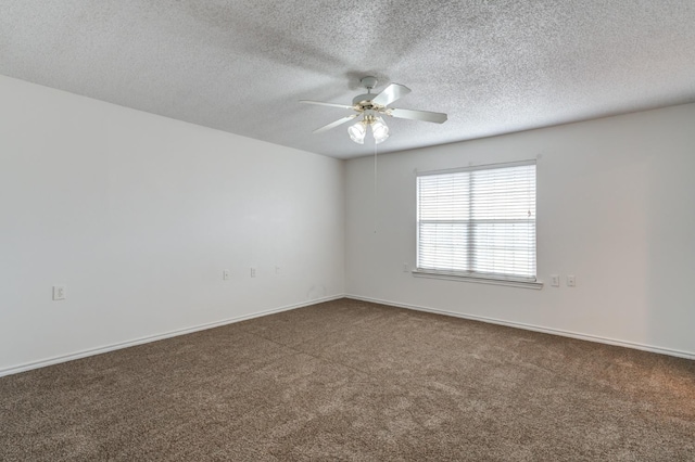 unfurnished room with dark colored carpet, a textured ceiling, and ceiling fan