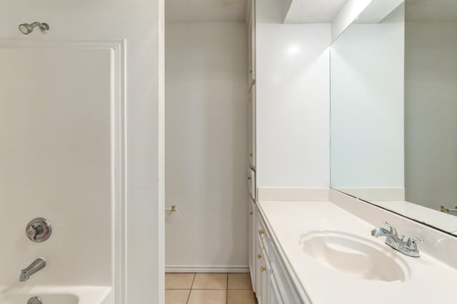 bathroom with vanity, bathtub / shower combination, and tile patterned flooring