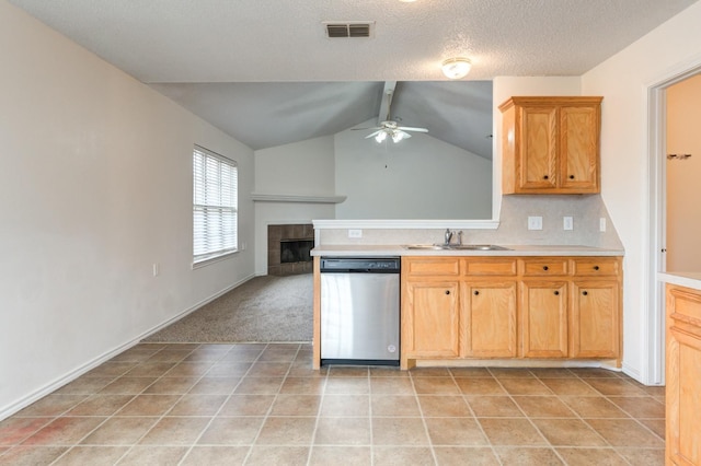 kitchen with a tile fireplace, sink, stainless steel dishwasher, light tile patterned floors, and ceiling fan