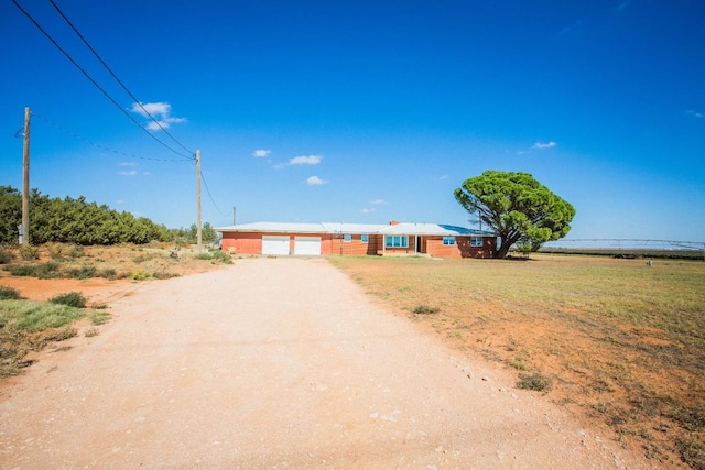 single story home with a rural view