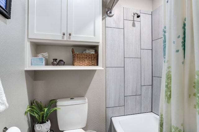 bathroom with toilet and shower / tub combo