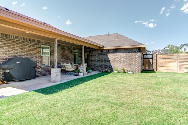 back of property featuring a yard and a patio area