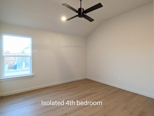 empty room featuring vaulted ceiling, ceiling fan, and light hardwood / wood-style floors