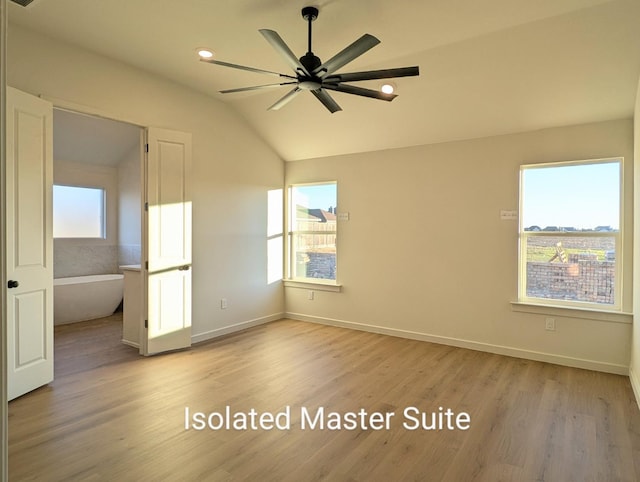 unfurnished bedroom featuring vaulted ceiling and light wood-type flooring