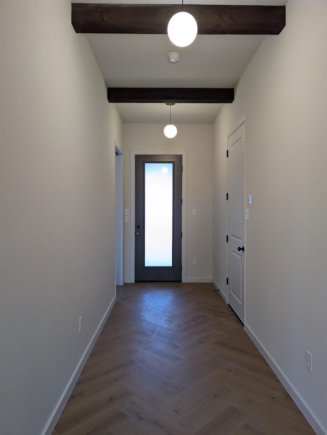 doorway to outside with parquet floors and beam ceiling