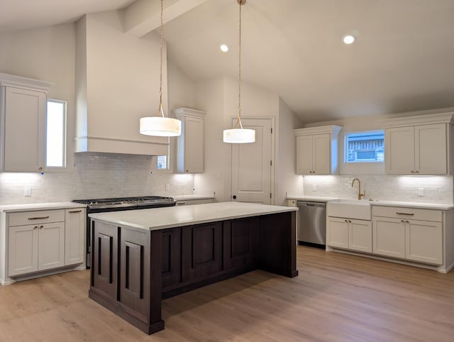 kitchen featuring sink, white cabinetry, a center island, dishwasher, and pendant lighting